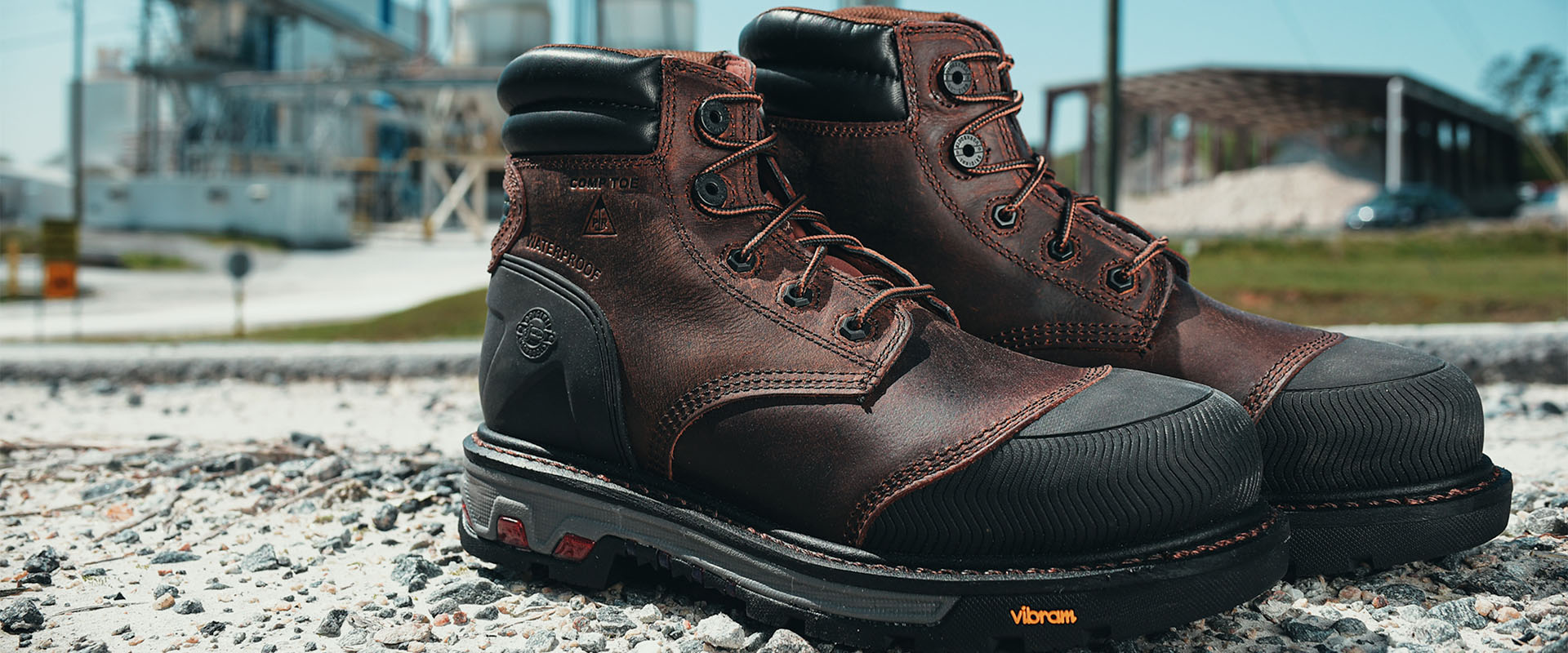 Pair of Justin Warhawk nano comp toe lace up boots in brown